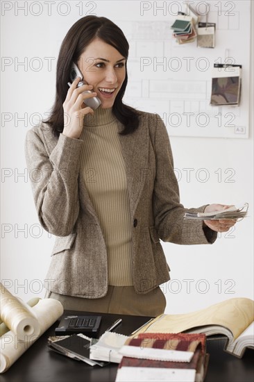 Female interior designer talking on cell phone.