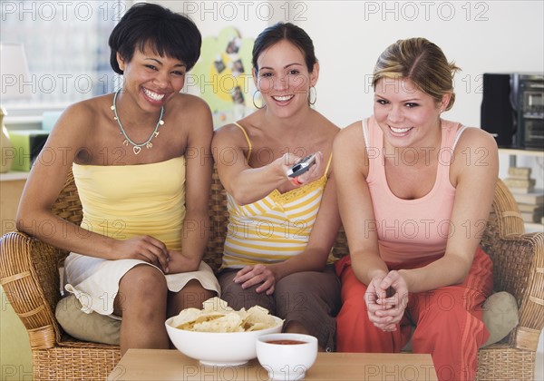 Multi-ethnic women watching television.