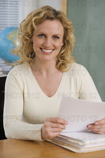 Portrait of female teaching in classroom.