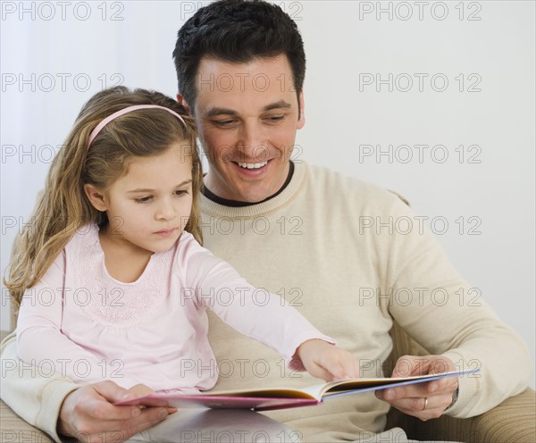 Father and daughter reading.