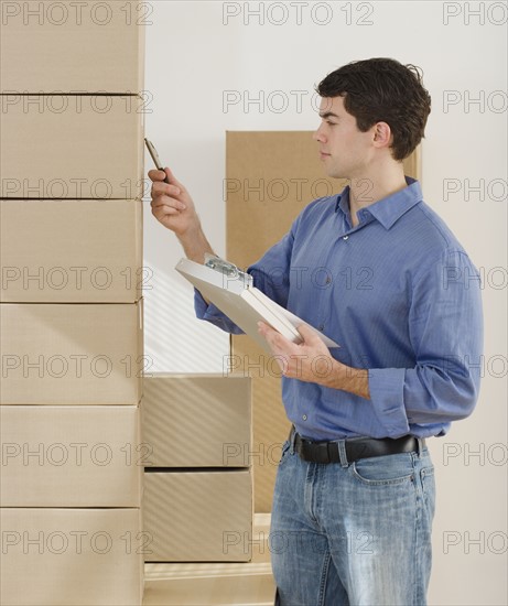 Man looking at stack of boxes.