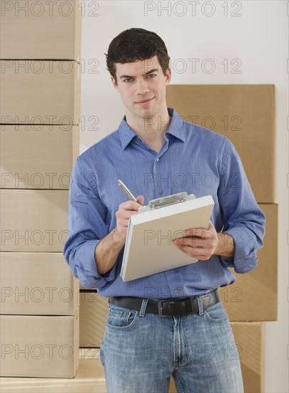 Portrait of man holding clipboard.