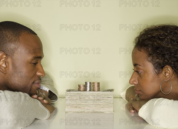 Couple looking at pile of money.