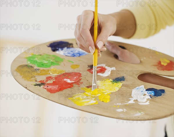 Close up of female artist using palette.