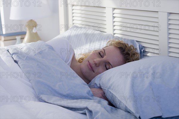 Woman sleeping in bed.