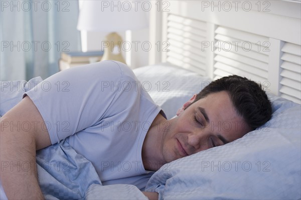 Man sleeping in bed.