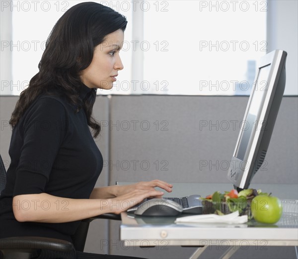 Businesswoman typing on computer.