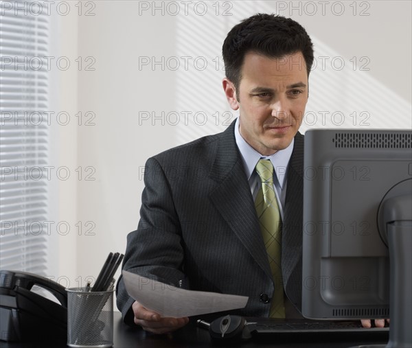 Businessman working at desk.