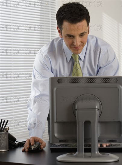 Businessman typing on computer.