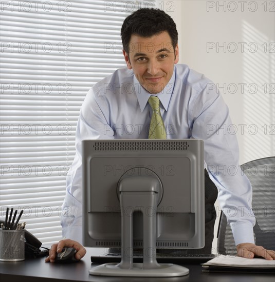 Portrait of businessman at desk.