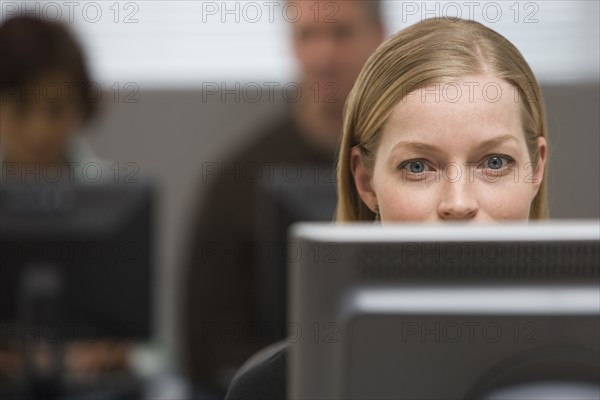 Businesswoman looking at computer.