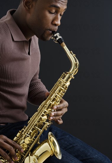 Close up of man playing saxophone.