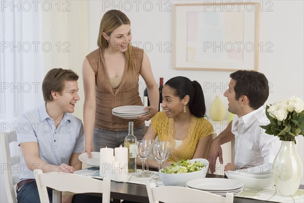 Two couples having dinner party.