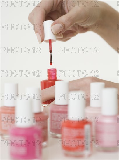 Close up of woman opening nail polish.