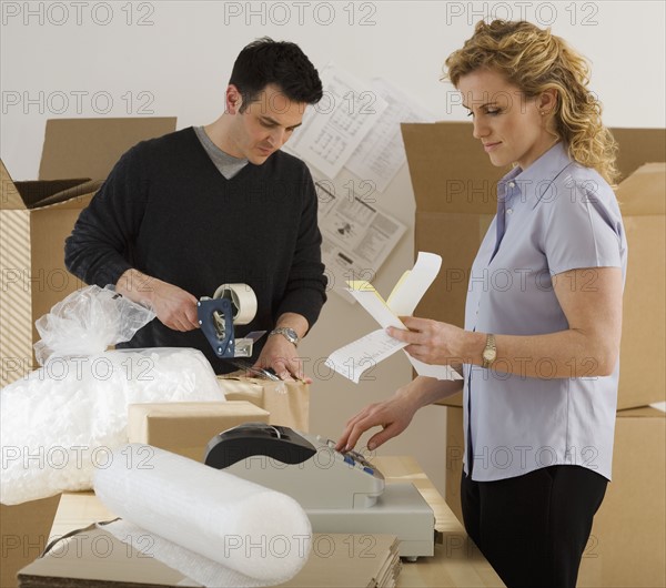 Businesspeople packing boxes.