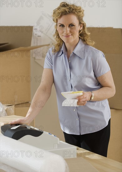 Portrait of woman holding receipts.