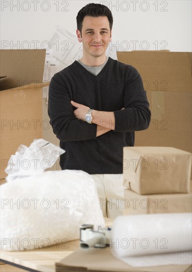 Portrait of man next to packing supplies.