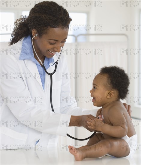 Female doctor examining baby.