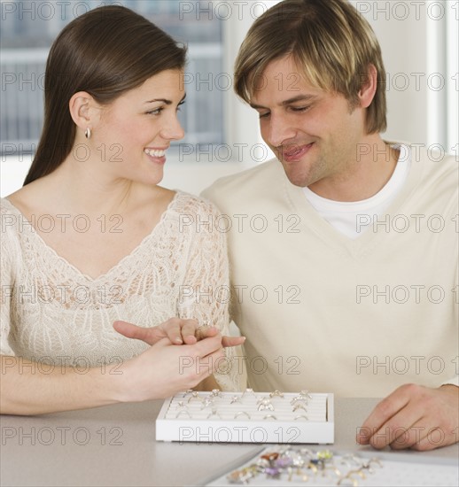 Couple looking at engagement rings.