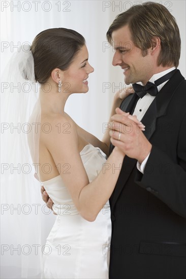 Bride and groom dancing.