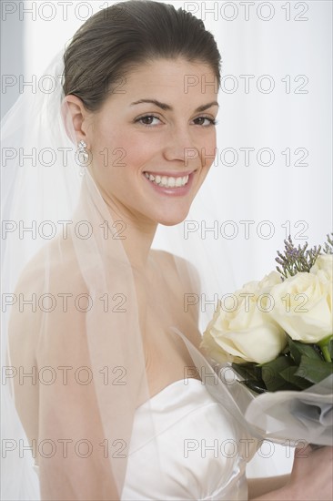 Portrait of bride holding bouquet.