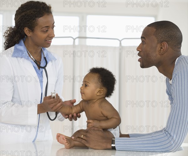 Female doctor examining baby.