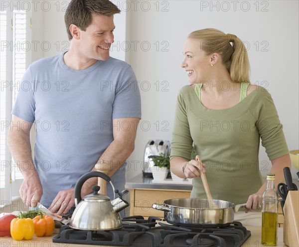 Couple cooking in kitchen.