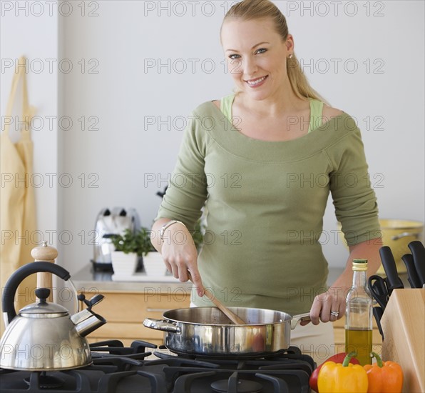 Woman cooking in kitchen.