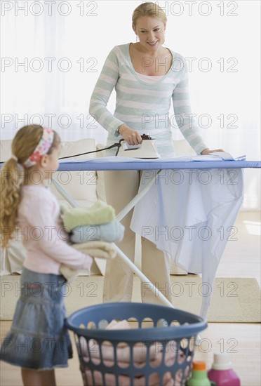 Mother and daughter doing laundry.