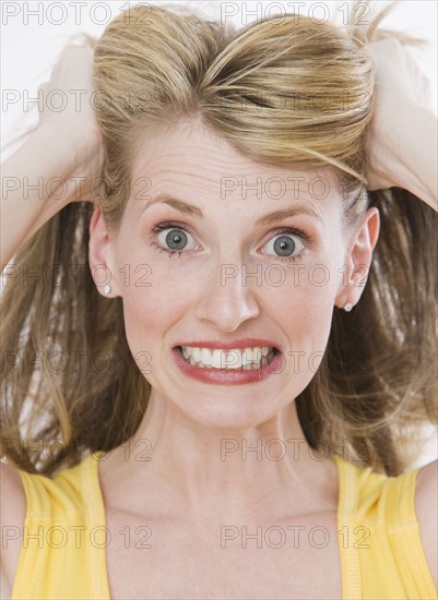 Frustrated woman pulling on hair.