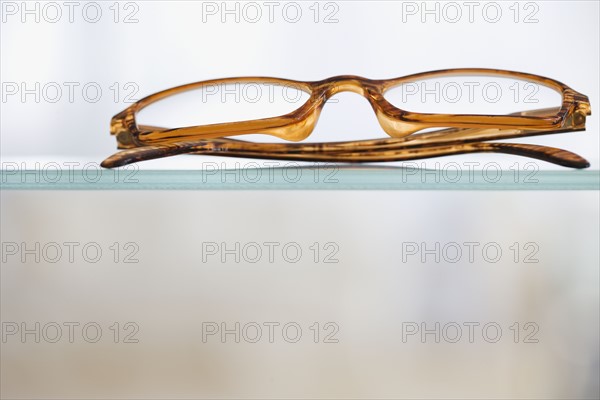 Close up of eye glasses on shelf.