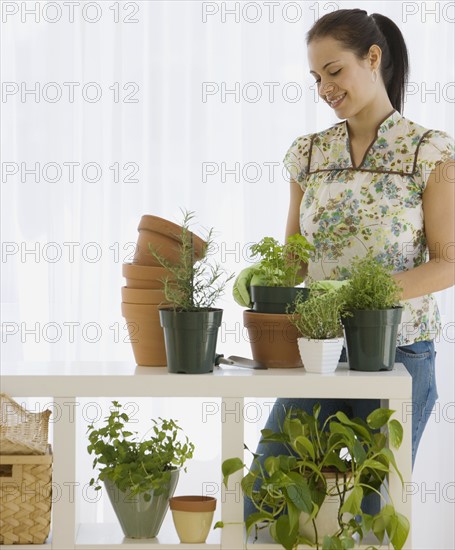 Woman potting plants.