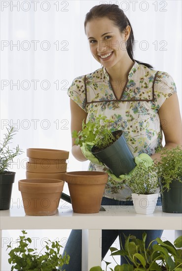 Woman potting plants.