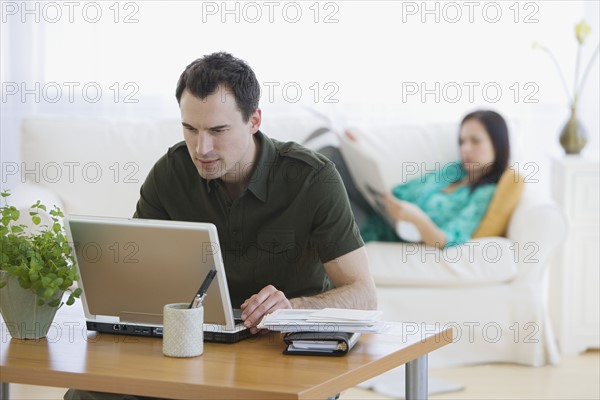 Couple relaxing in living room.