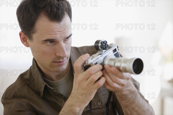 Man looking through camera.