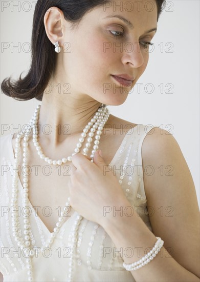 Woman wearing pearl jewelry.