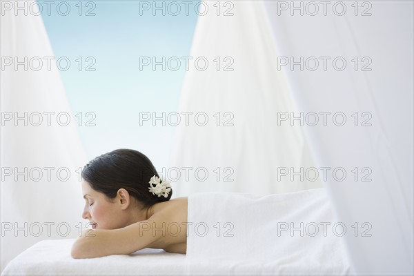 Woman laying on spa table.