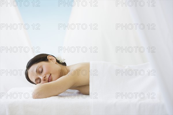 Woman laying on spa table.