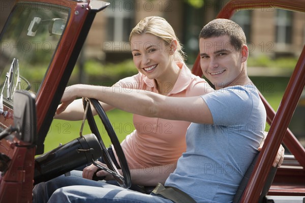 Couple sitting in jeep.