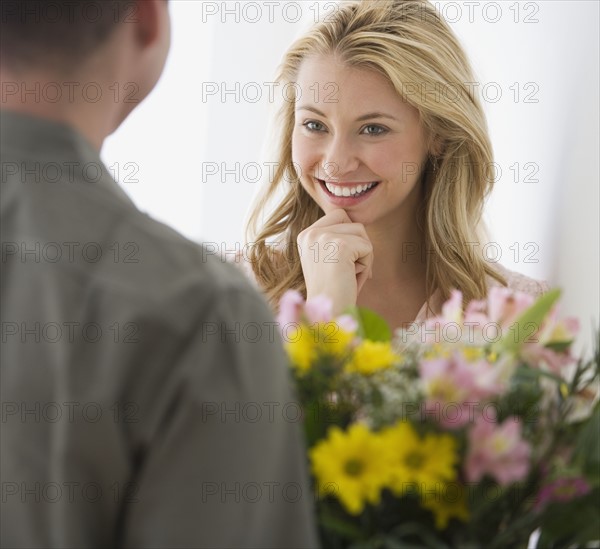 Woman receiving flowers from boyfriend.