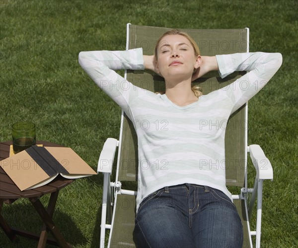 Woman sitting in lounge chair.