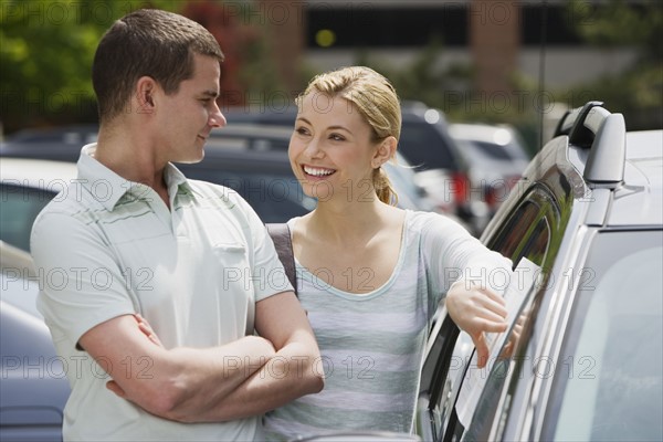 Couple looking at new car.