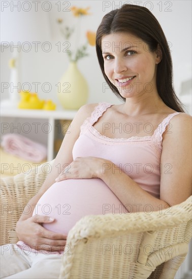 Pregnant woman with hands on belly.