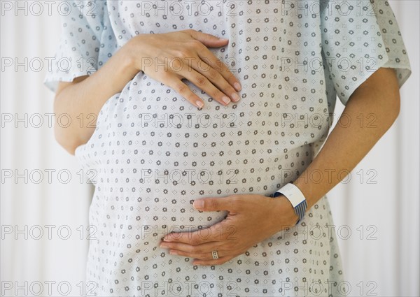 Pregnant woman in hospital gown.