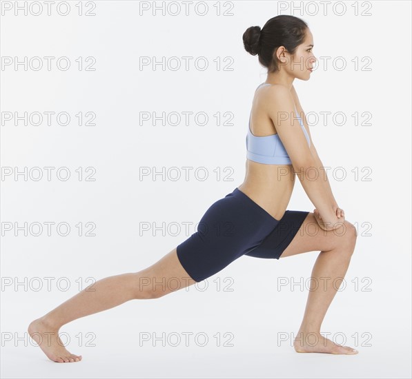 Studio shot of woman stretching.