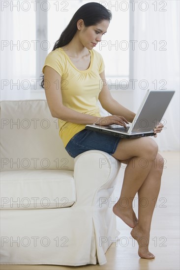 Woman typing on laptop.