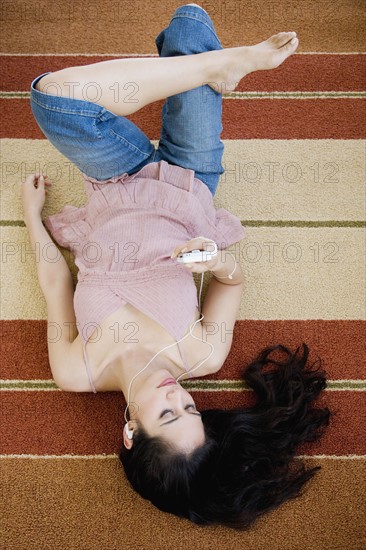 Woman listening to mp3 player.