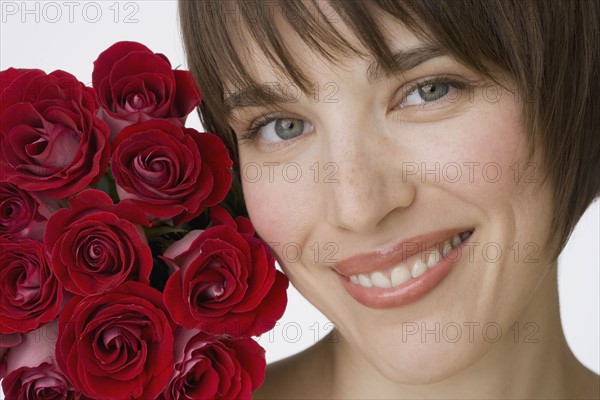 Close up of woman next to flowers.