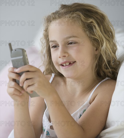 Girl dialing cell phone.