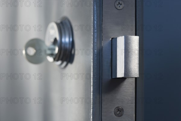 Close up of key in door lock.